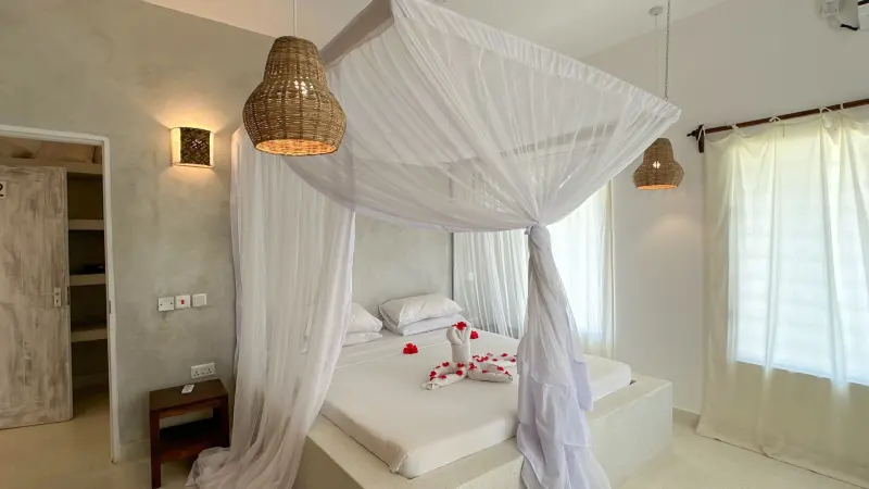 A four-poster bed hung with white nets