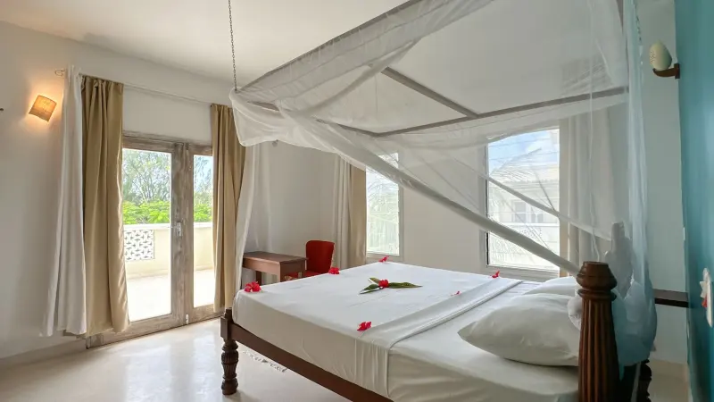 A double bed under a white mosquito net