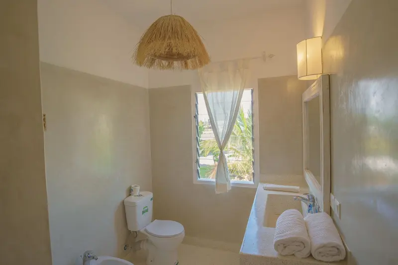 A bathroom under a rattan lamp