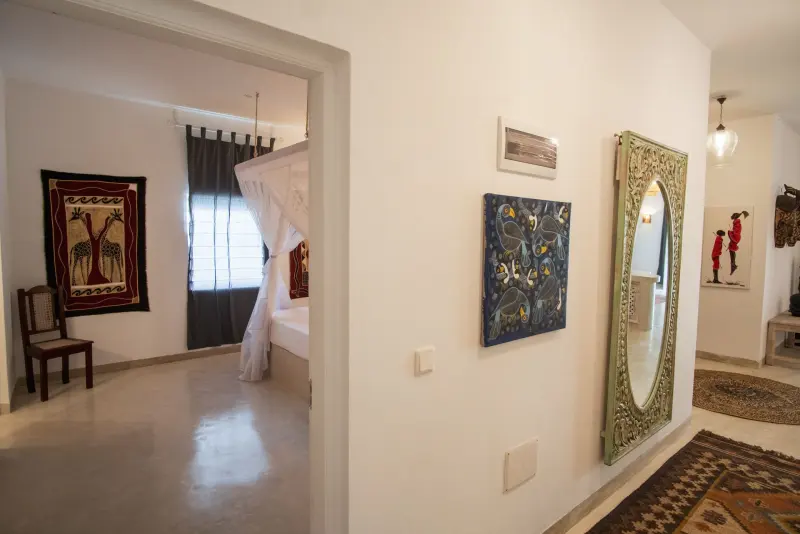 A bedroom doorway framed by artwork